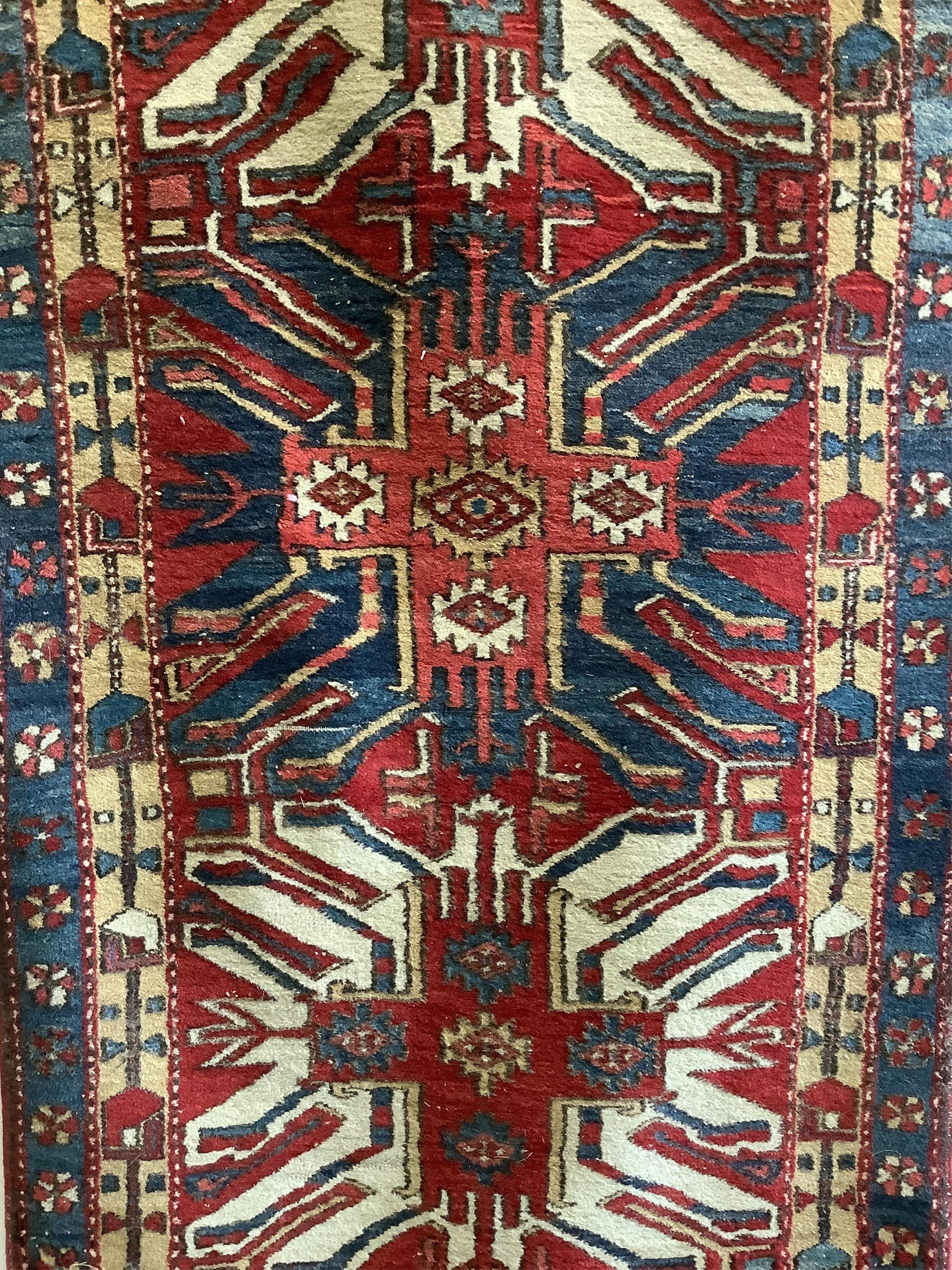 A Caucasian runner with stylised eagle motifs, 330 x 103cm